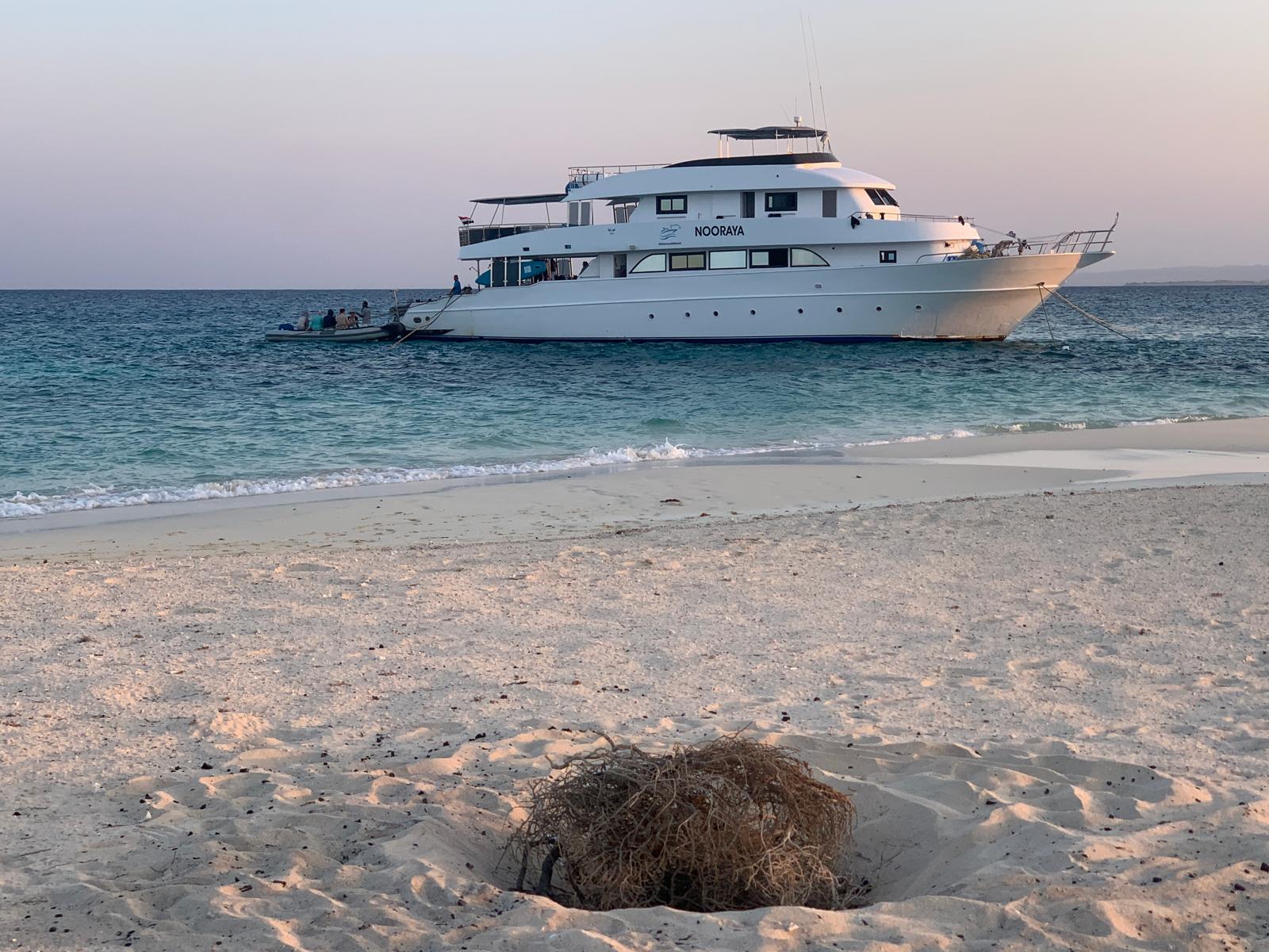 The Nooraya anchored off a sandbank at dusk