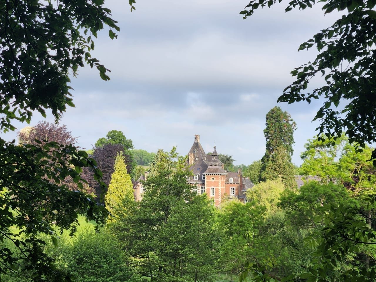 Château Cortils glimpsed through the trees