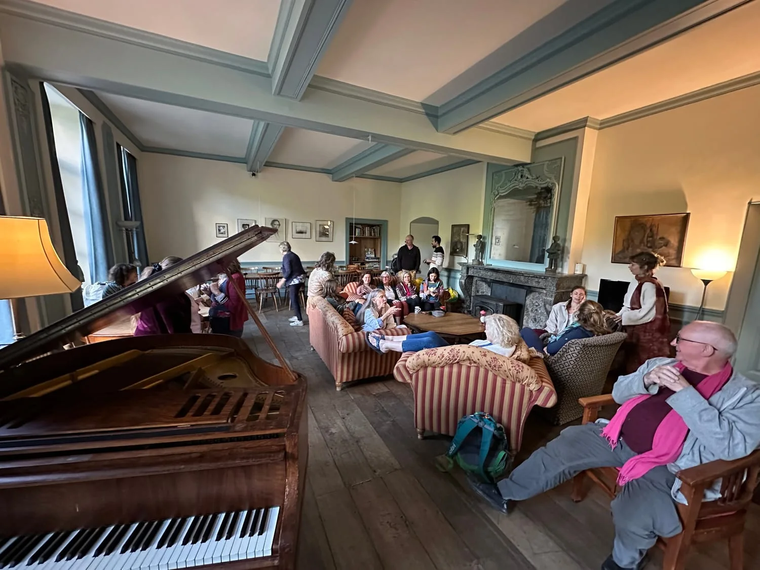 A gathering around the grand piano in the salon